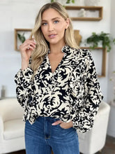 Black and white floral print blouse with ruffled balloon sleeves ideal for styling with jeans size options