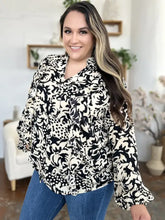 Black and white floral printed blouse with ruffle trim balloon sleeves and v-neckline ideal for jeans size styling