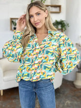 A vibrant double take full size printed smocked long sleeve blouse with bold abstract wave pattern in teal yellow orange and white