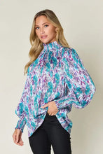 A vibrant double take full size printed smocked long sleeve blouse with high neck and puff sleeves in teal purple and white