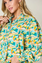 A vibrant double take full size printed smocked long sleeve blouse with teal yellow cream abstract wave pattern and puffed sleeves