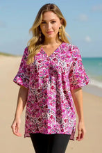 Double take full size printed v-neck short sleeve blouse featuring a vibrant pink and white floral pattern with a v-neckline