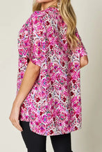 A vibrant pink and white floral patterned double take full size printed v neck short sleeve blouse with short sleeves