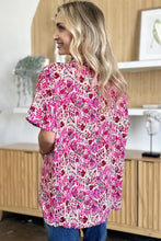 A vibrant pink and magenta floral print double take full size printed v-neck short sleeve blouse with short sleeves