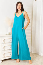 Vibrant turquoise spaghetti strap tied wide-leg rayon jumpsuit, machine wash cold