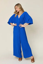Vibrant royal blue surplice wide leg jumpsuit with deep v-neck and bell sleeves