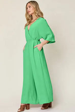 Vibrant royal blue surplice wide leg jumpsuit with pockets