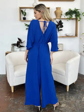 Royal blue surplice wide leg jumpsuit with back tie and pockets