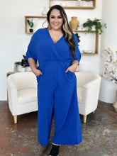 Vibrant royal blue surplice wide leg jumpsuit with pockets