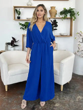 Vibrant royal blue surplice wide leg jumpsuit with v-neck and pockets