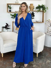 Royal blue surplice wide leg jumpsuit with cinched waist and pockets