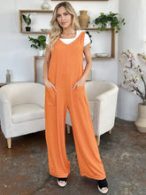 Orange ribbed Double Take jumpsuit with white top, professionally dry clean