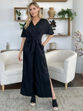 Black satin maxi dress with V-neck, flutter sleeves, tie belt, machine wash cold
