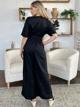 Black satin jumpsuit with short sleeves, belted waist, machine wash cold