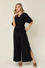 Black wide-leg v-neck jumpsuit with 3/4 sleeves, tie belt, machine wash cold