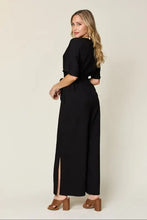 Black wide-leg jumpsuit with short sleeves, side slit, machine wash cold