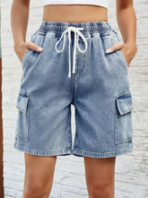 Light wash blue drawstring denim shorts with waist stretch and pockets