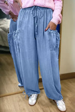 Light blue denim loose fit cargo pants with drawstring elastic waist and side pockets for casual wear