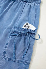 Blue denim loose fit cargo pants with drawstring elastic waistband and multiple pockets for casual wear