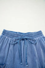 Blue denim loose fit shorts with drawstring elastic waistband and pockets for casual comfort