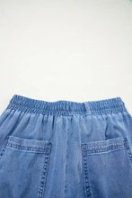 Blue denim drawstring elastic waist skirt with loose fit and two front pockets for casual wear