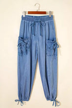 Light blue denim drawstring elastic waist loose fit cargo pants with pockets and ankle ties for casual wear