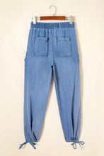 Light blue denim loose fit joggers with drawstring elastic waistband and adjustable drawstring cuffs