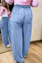 Light blue denim drawstring elastic waist pocketed loose fit cargo pants with side drawstrings and elastic waistband