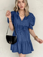 Black leather crossbody bag with gold-tone buckle paired with high waist denim mini dress with puff sleeves