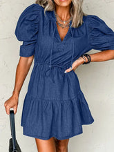 Denim mini dress with high waist drawstring, puffed sleeves, and tiered skirt in classic blue denim fabric