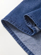 Dark blue denim mini dress with classic twill weave and visible stitching on folded hem featuring high waist design