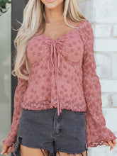 A dusty rose floral lace blouse featuring a drawstring knot ruched front and long sleeves with a tied bow detail