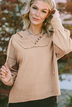Light brown drawstring long sleeve hoodie with V-neck and ruffled sleeves
