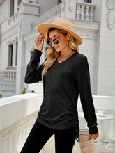 Black long sleeve V-neck top with adjustable ruched sides