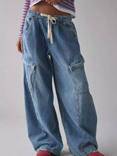 Light-wash denim cargo jeans with a drawstring waist and large side pockets for versatile casual wear