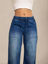 Blue denim drawstring waist wide leg jeans with a drawstring waistband and two front pockets in jogger style