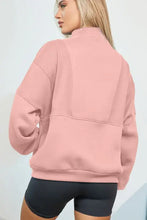 Dusty rose pink zip-up hoodie with oversized pockets and ribbed cuffs