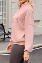 Dusty rose pink zip-up hoodie with oversized pockets and ribbed cuffs
