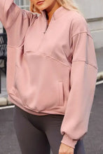 Dusty rose pink zip-up hoodie with oversized pockets and ribbed cuffs