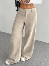Beige wide leg corduroy pants with relaxed fit and front pockets made from soft corduroy fabric