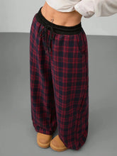 Red and black plaid wide leg pants with black elastic waistband and drawstring for comfortable casual wear