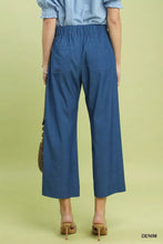 Back view of blue umgee denim wide leg crop pants featuring high-waisted elastic waistband and two back pockets