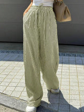 Striped wide leg pants with vertical olive and black stripes made of lightweight fabric for comfortable wear
