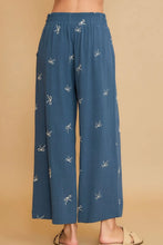 Blue wide-leg pants with lace drawstring and subtle white bow embroidered pattern umgee plus size design