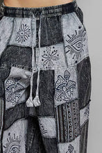 Black and gray patchwork wide leg pants with drawstring featuring embroidered mystical eyes mushrooms and flowers