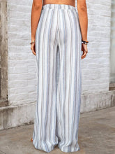 Full size striped wide leg pants in light blue and white vertical stripes made of lightweight fabric for plus size wear
