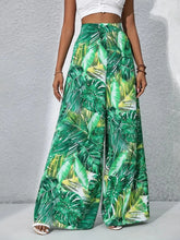 Printed high waist wide leg pants with green tropical leaf print perfect for casual summer wear