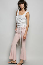 Soft pink textured ribbed knit flare pants with drawstring waist and side pockets from pol collection