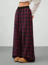 Red and black plaid wide leg pants with a drawstring waist in soft fabric for comfortable casual wear
