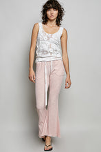 A soft pink ribbed knit pants with a textured wide-leg design, drawstring waist, and side pockets from pol
